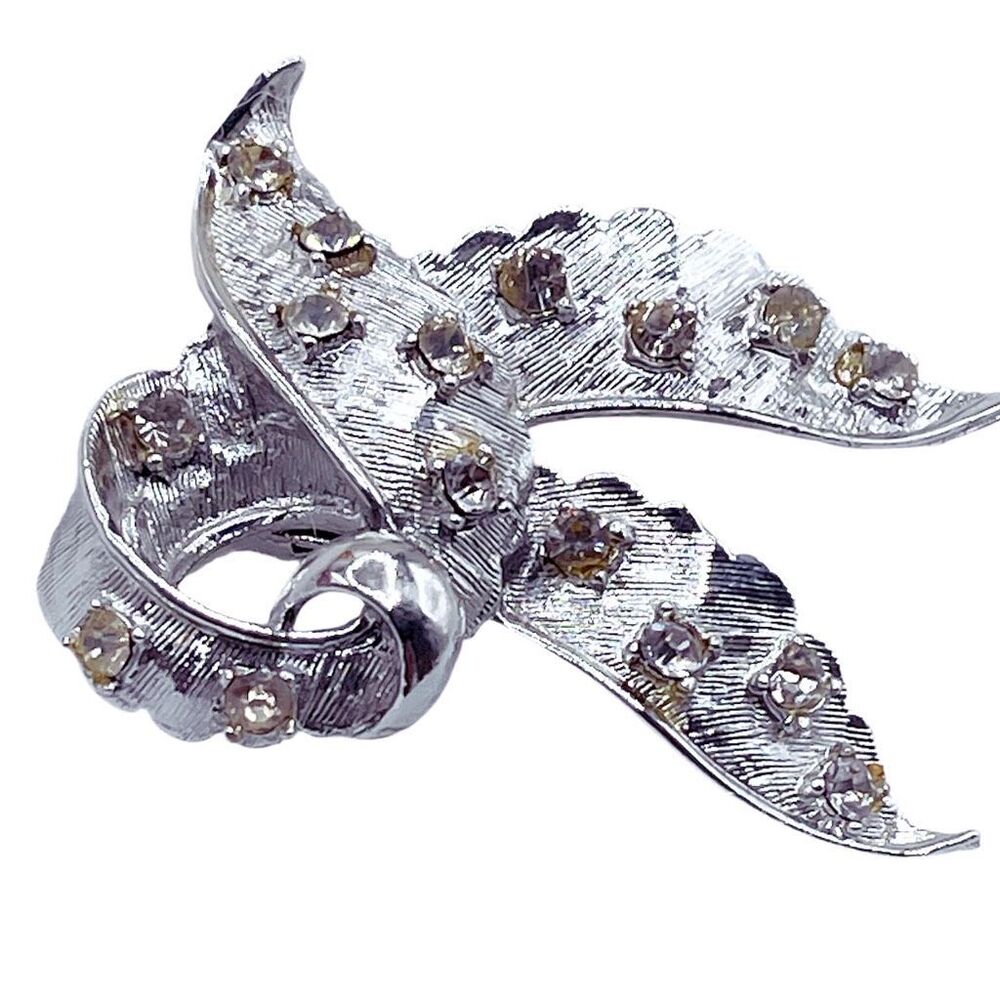 Vintage silver with pale yellow rhinestones brooch.